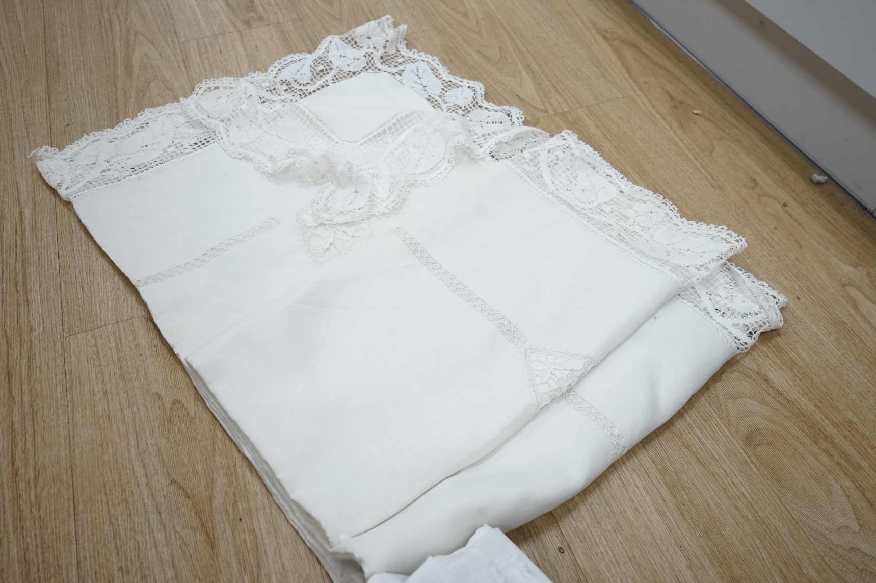 A French provincial linen sheet with lace edge and insertions plus a pair of similar sheets with drawn thread and monograms